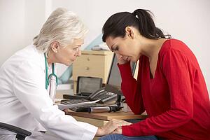 American doctor with depressed woman patient