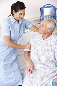 Nurse helping male patient in UK Accident and Emergency