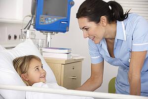 Nurse with child patient in UK Accident and Emergency