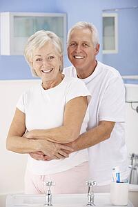 Senior couple hugging in bathroom