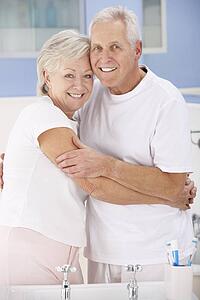 Senior couple hugging in bathroom