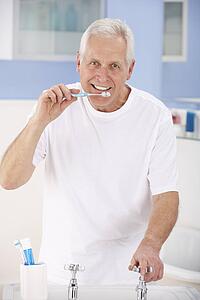 Senior man brushing teeth
