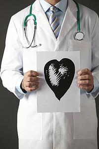 American doctor holding ink drawing of heart