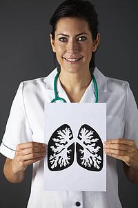 American nurse holding ink drawing of lungs