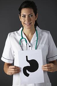 American nurse holding ink drawing of stomach