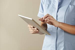 UK nurse using computer tablet