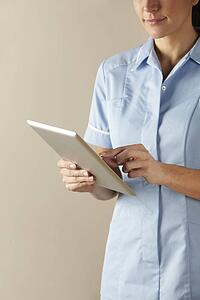 UK nurse using computer tablet
