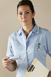 UK nurse holding prescription drug pack