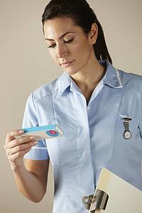 UK nurse holding prescription drug pack
