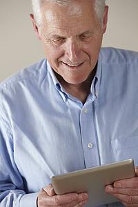 Senior man using tablet