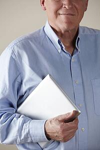 Senior man holding tablet