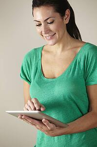 Woman using tablet studio shot