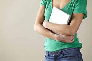 Woman holding tablet studio shot