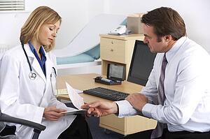 American doctor talking to businessman patient