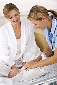 Nurse with mother and newborn baby