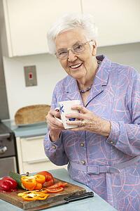 Senior woman preparing food in domestic kitchen