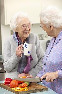 Senior women preparing meal together