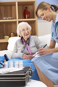 UK nurse visiting senior woman at home