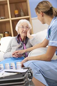 UK nurse visiting senior woman at home