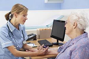 UK nurse injecting senior woman patient