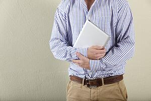 Cropped Studio Shot Of Young Man Holding Tablet Computer