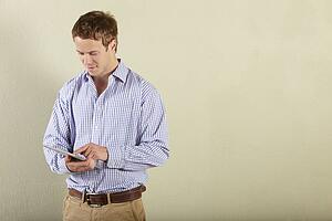 Studio Shot Of Young Man Using Tablet Computer