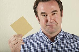 Studio Shot Of Middle Aged Man Holding Wage Packet