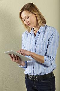 Studio Shot Of Middle Aged Woman Using Tablet Computer