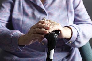 Close Up Of Senior Woman Holding Walking Stick