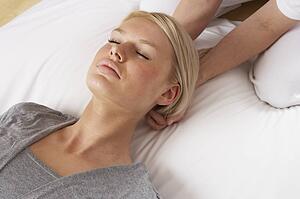 Woman having Shiatsu massage to head