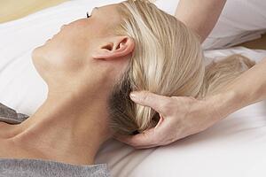 Woman having Shiatsu massage to head