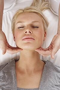 Woman having Shiatsu massage to head