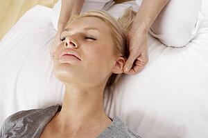 Woman having Shiatsu massage to head