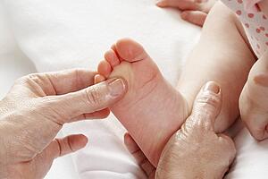 Detail baby having foot massage