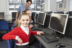 Girls using computers in school class