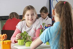 Girl learning about plants in school class