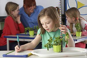 Girl learning about plants in school class