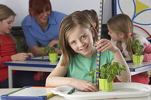 Girl learning about plants in school class