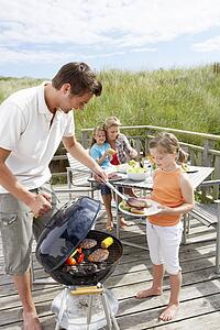 Family on vacation having barbecue