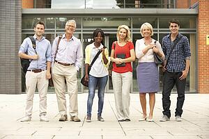 Mixed group of students outside college