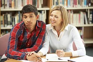 College tutor with student