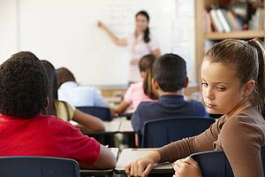 Unhappy schoolgirl in class
