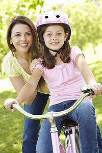 Girl on bike with mother