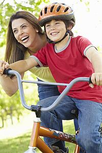 Boy on bike with mother
