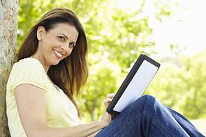 Woman using tablet outdoors