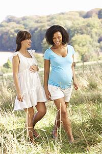 Pregnant women outdoors in countryside