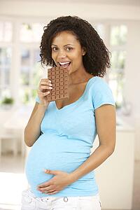Pregnant woman eating chocolate