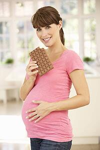Pregnant woman eating chocolate