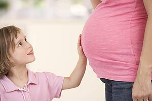 Pregnant woman with daughter