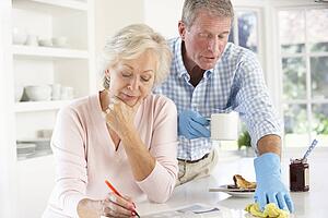 Retired man clearing up after breakfast